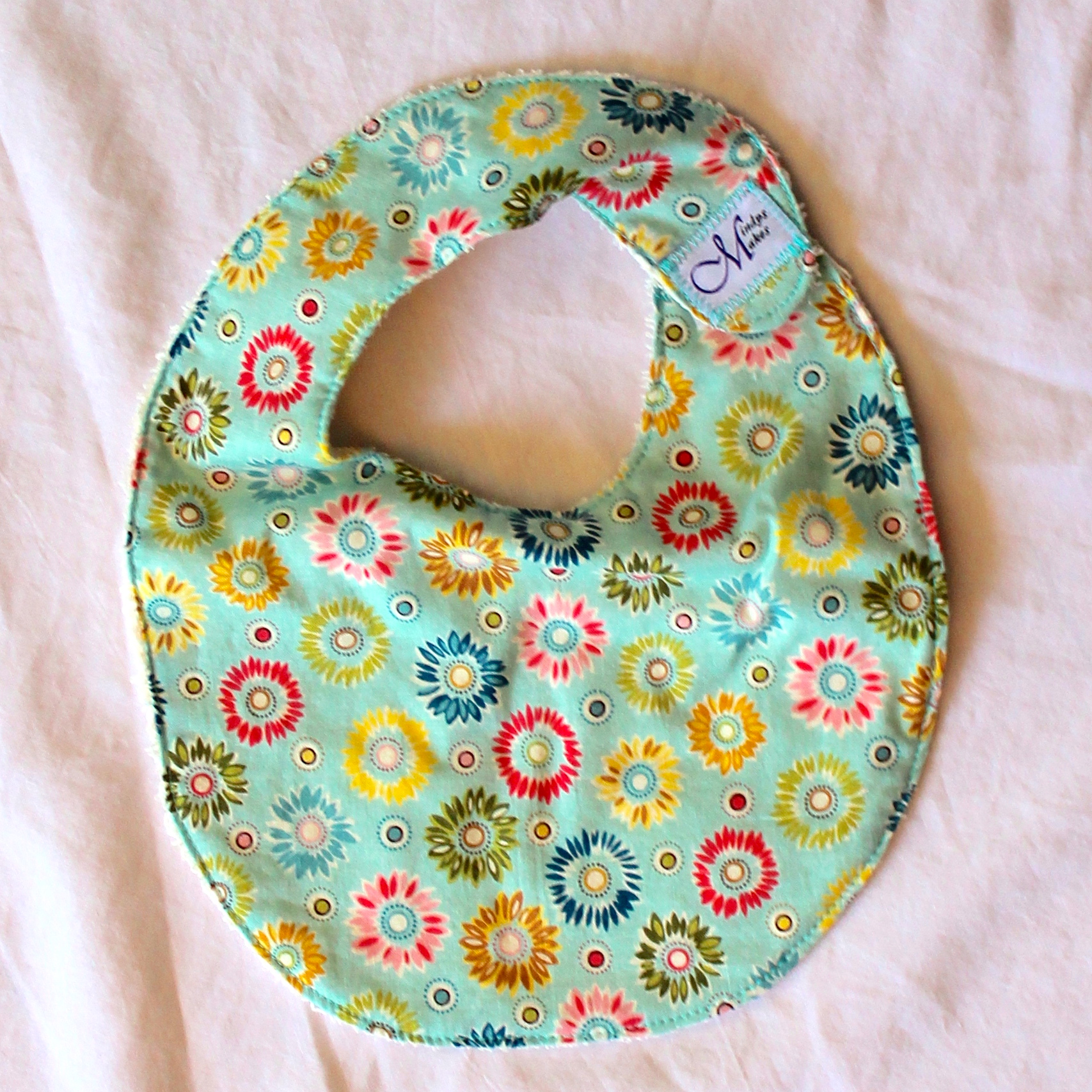 Small Green, Yellow, Pink and Blue Scribbled Flower Bib